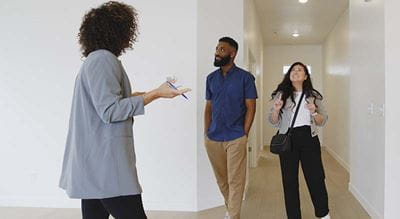 Realtor showing a couple an empty home