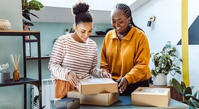 Two people looking at packages in a small space