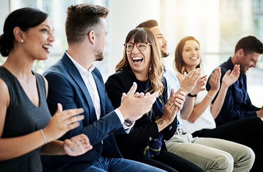 Employees applauding and smiling