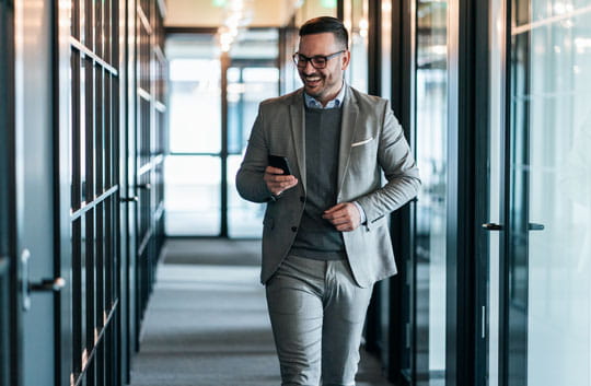 Businessman walks down hallway