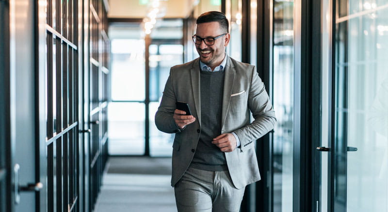Businessman walks down hallway