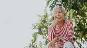 A senior woman sitting outside