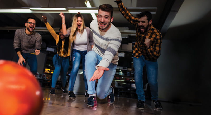 Friends bowling together