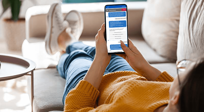 Person on couch using the virtual assistant on a phone