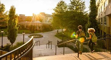 Students walking down stairs on college campus