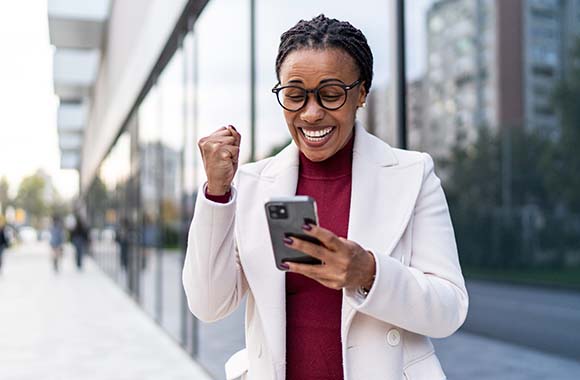Excited person looking at a cellphone