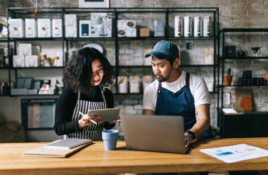 Two workers review inventory