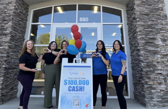 Banner Redding branch employees with Dream Big sign