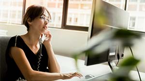 Business woman on her phone and computer