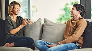 Couple sitting on couch and smiling