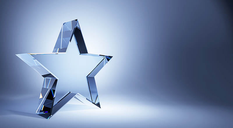 Glass star trophy on blue background