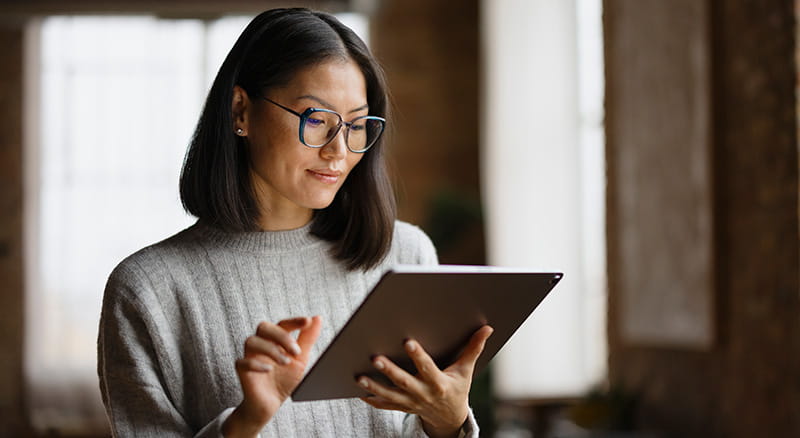 Person holding and looking at tablet