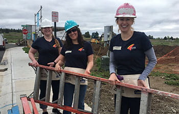 Banner Bank employees carrying ladder at volunteer event