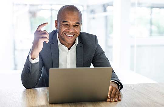 a man completes a video interview on a laptop