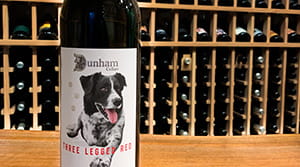 Dunham cellars wine bottle with wine rack in background