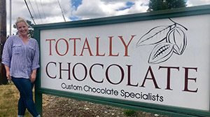 Totally Chocolate sign and owner