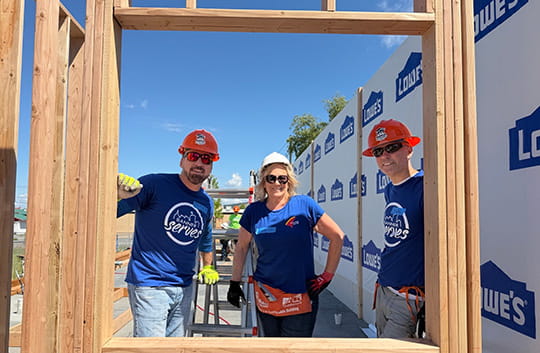 Banner employees framing a home with Habitat for Humanity