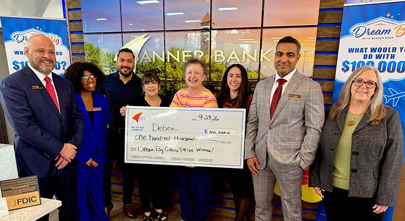Dream Big Grand Prize Winner with large check and Banner Bank staff at Banner branch
