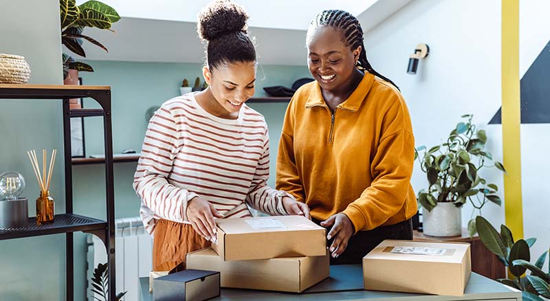 Two people looking at packages in a small space
