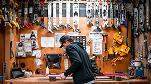 Man in workshop working on a snowboard