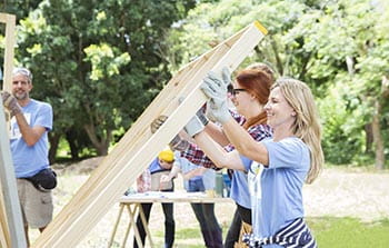 Group of volunteers framing a home