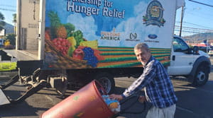 Person loading donated food onto truck
