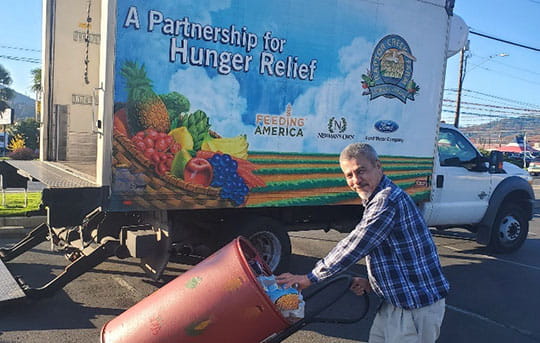 Person loading a large amount of food into a truck