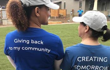 Two Banner employees take a break during Habitat Women Build event