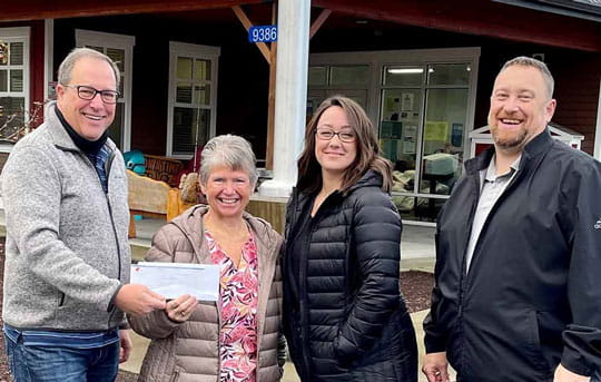 Banner employees present donation to food bank