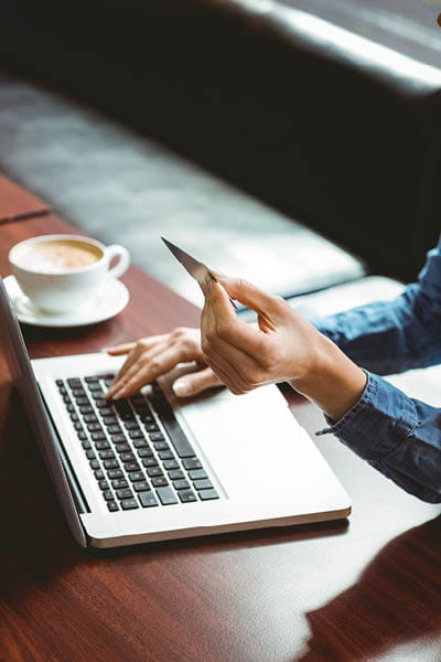 Person on computer with their debit card