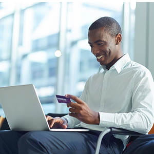 guy with computer and credit card at the airport