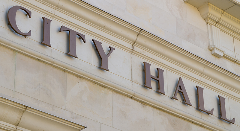 City hall sign on exterior of marble building in a city served by Banner Bank