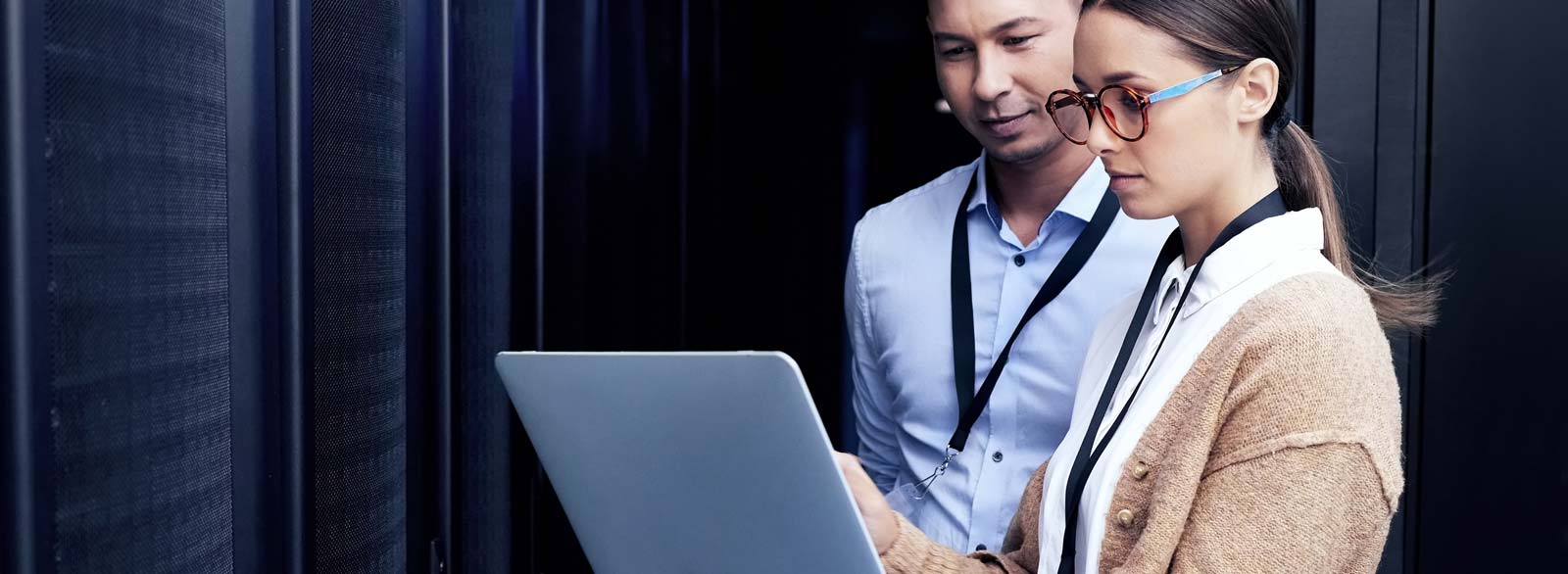 Two employees check company servers