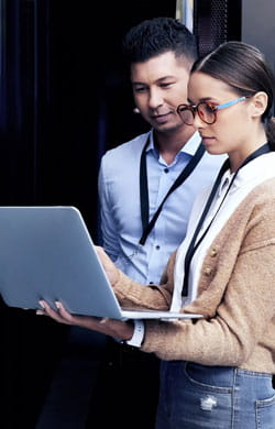 Two employees check company servers