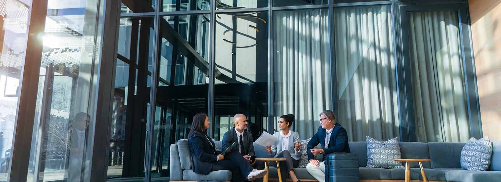 Colleagues sitting at a table in a large lobby