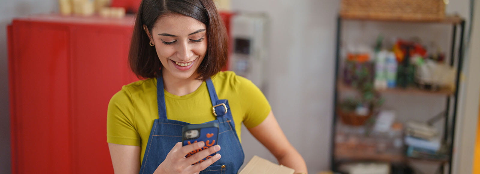 Person on phone and holding a box