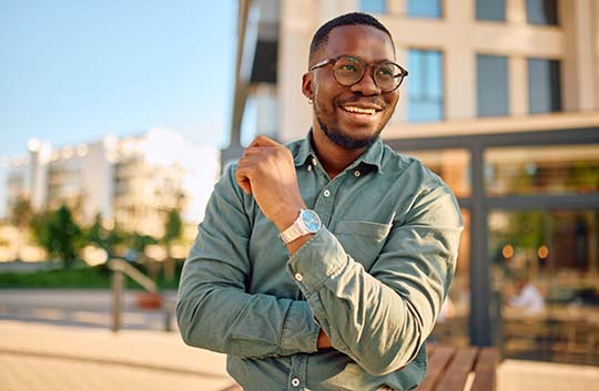 Person outside a building smiling