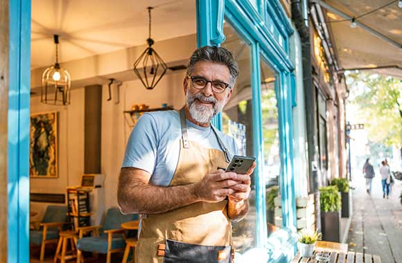 person on phone in shop doorway