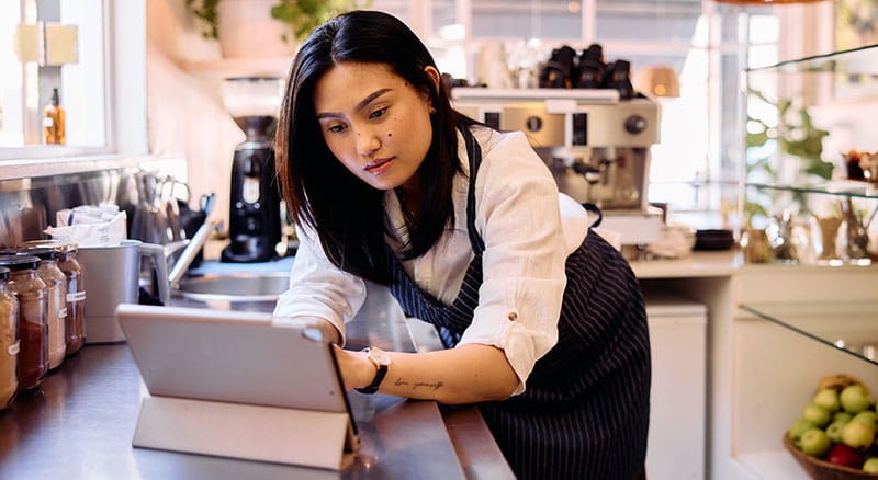 Person looking at tablet in commercial kitchen