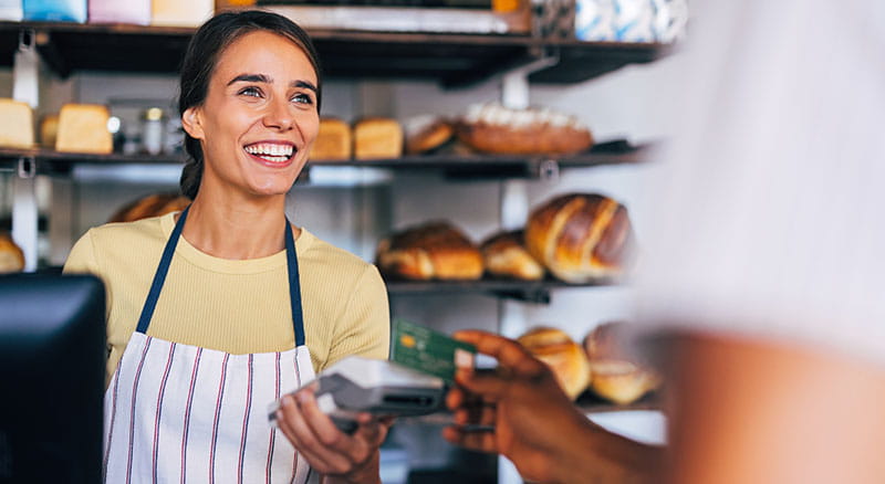 Person paying with card at a bakery