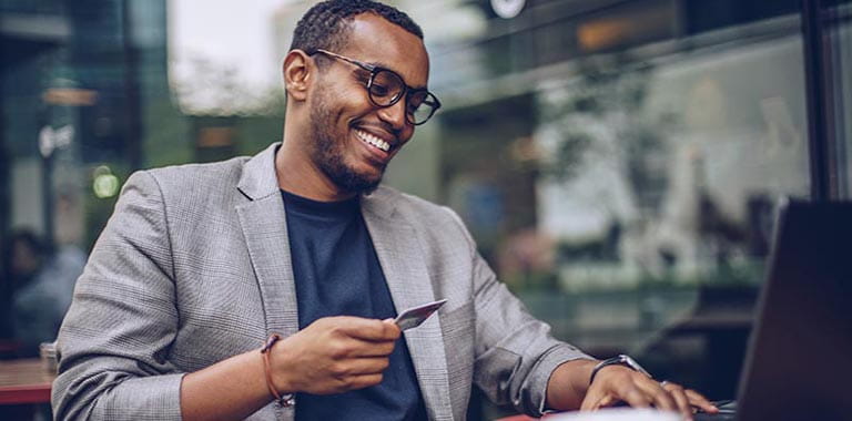 Person using debit card at computer