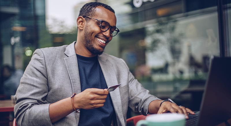 Person at computer with card
