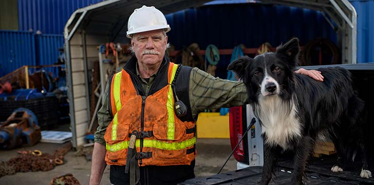 Worker posing with dog in truck