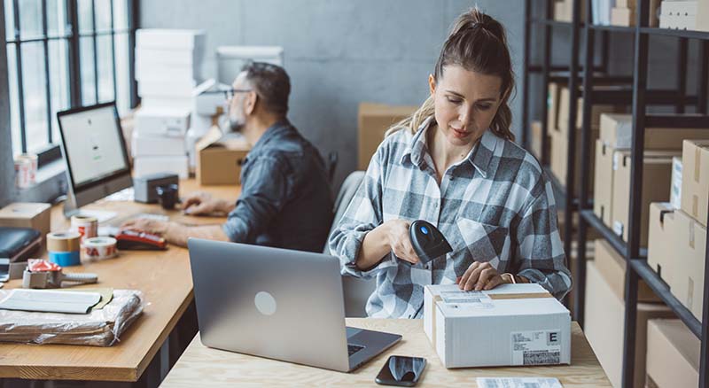 Person packing up a purchase in a small office