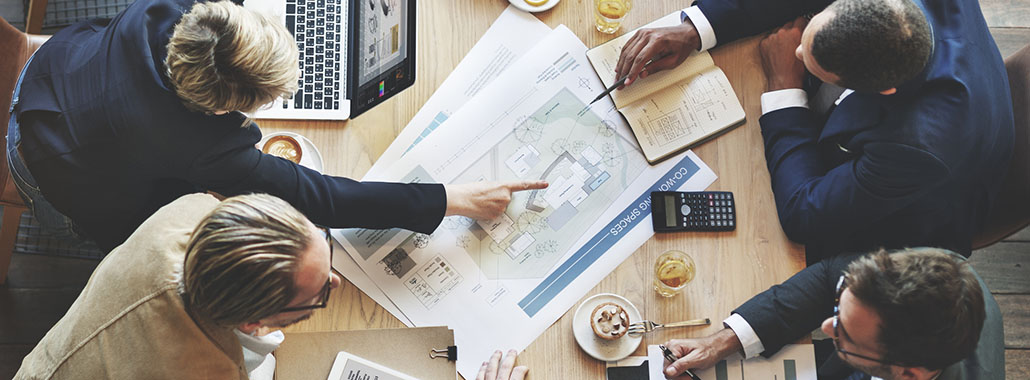 Businessmen going over financial paperwork in a conference room