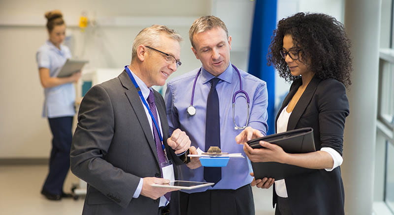 Executives looking at paperwork in a medical setting