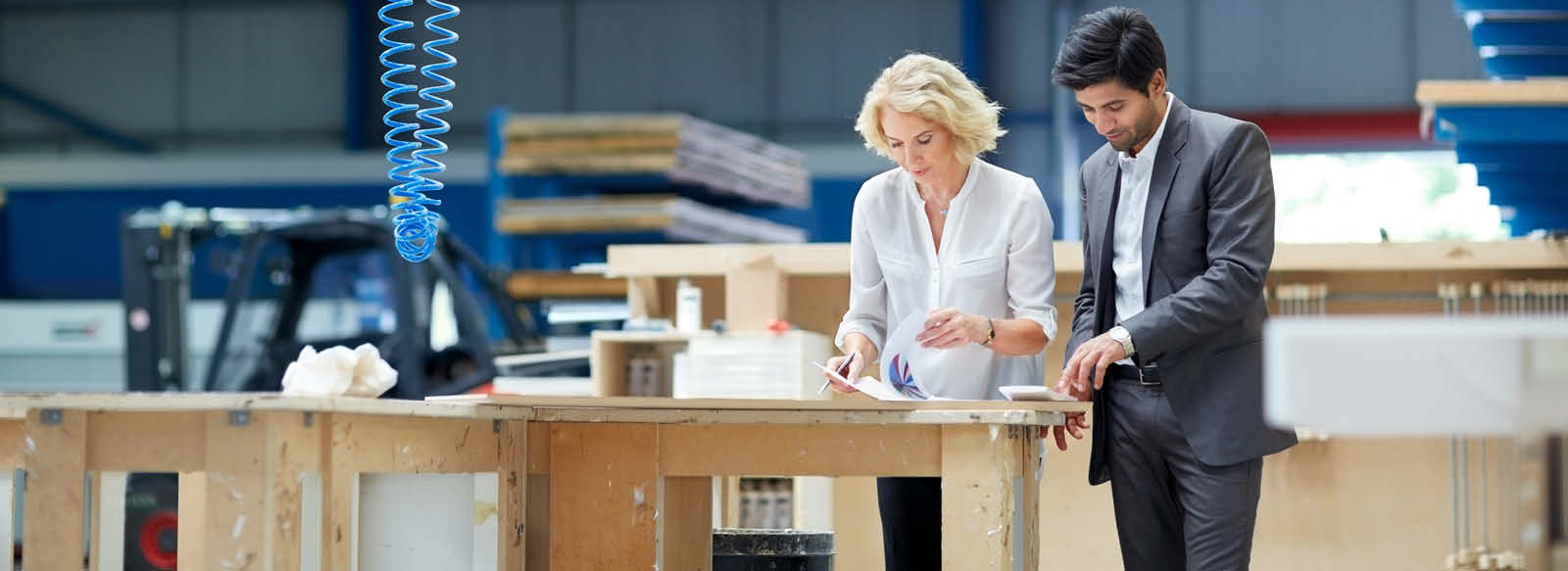 Man and woman looking at paperwork in warehouse