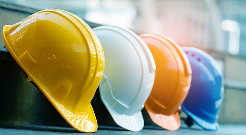 4 hard hats lined up outside