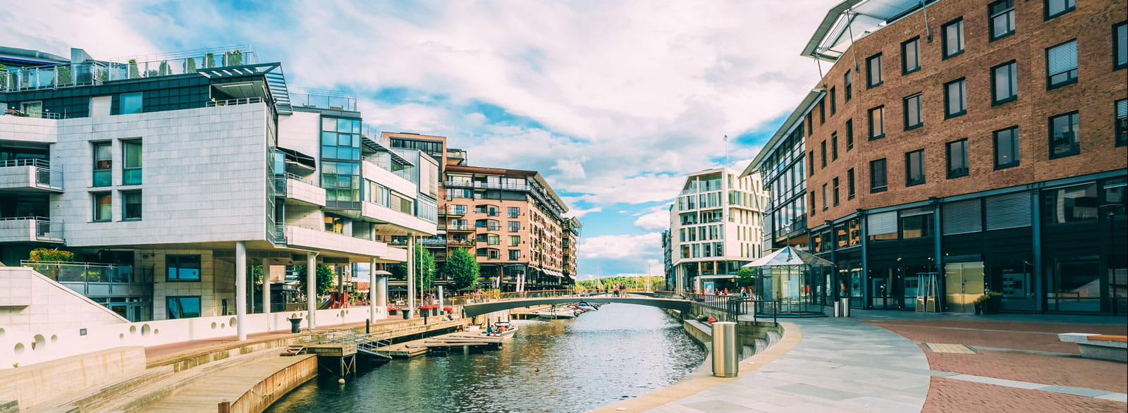 Planned community with walkways surrounding a water feature and mixed use buildings for living and working.