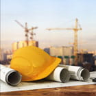 Hard hat and design plans on an income property construction site financed by Banner Bank